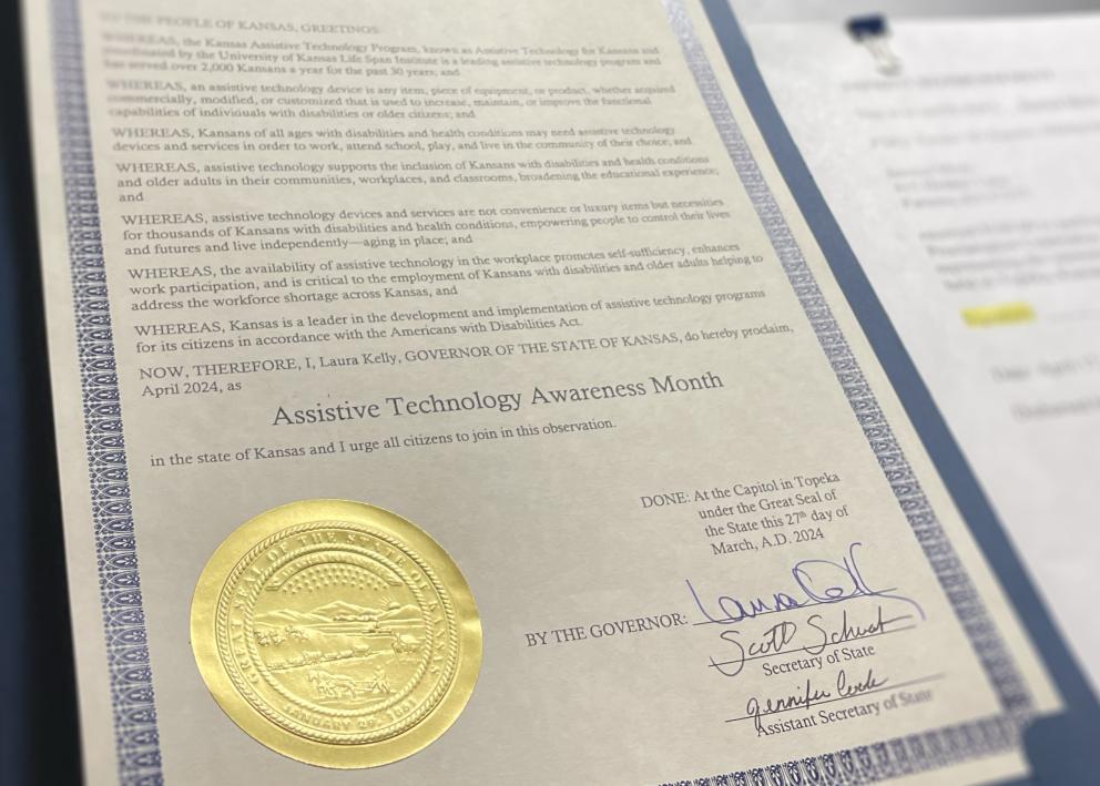 A proclamation with the seal of Kansas designates Assistive Technology Month 
